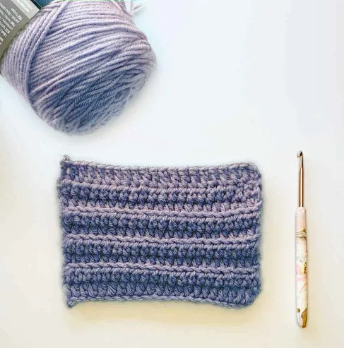 crochet sample with straight even edges, yarn, crochet hook