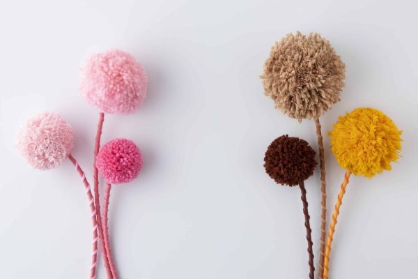 colorful-pom-poms-arrangement-top-view